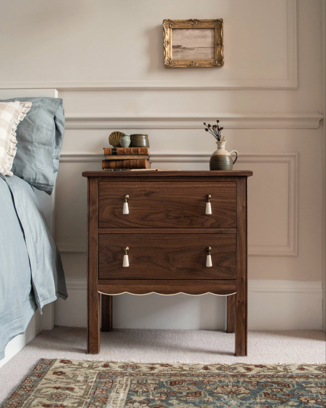 Wooden nightstand with decorative items in a bedroom setting