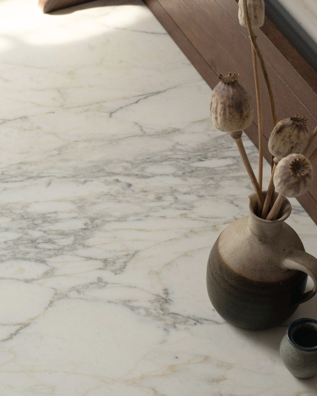 Decorative vase with dried plants on a marble surface