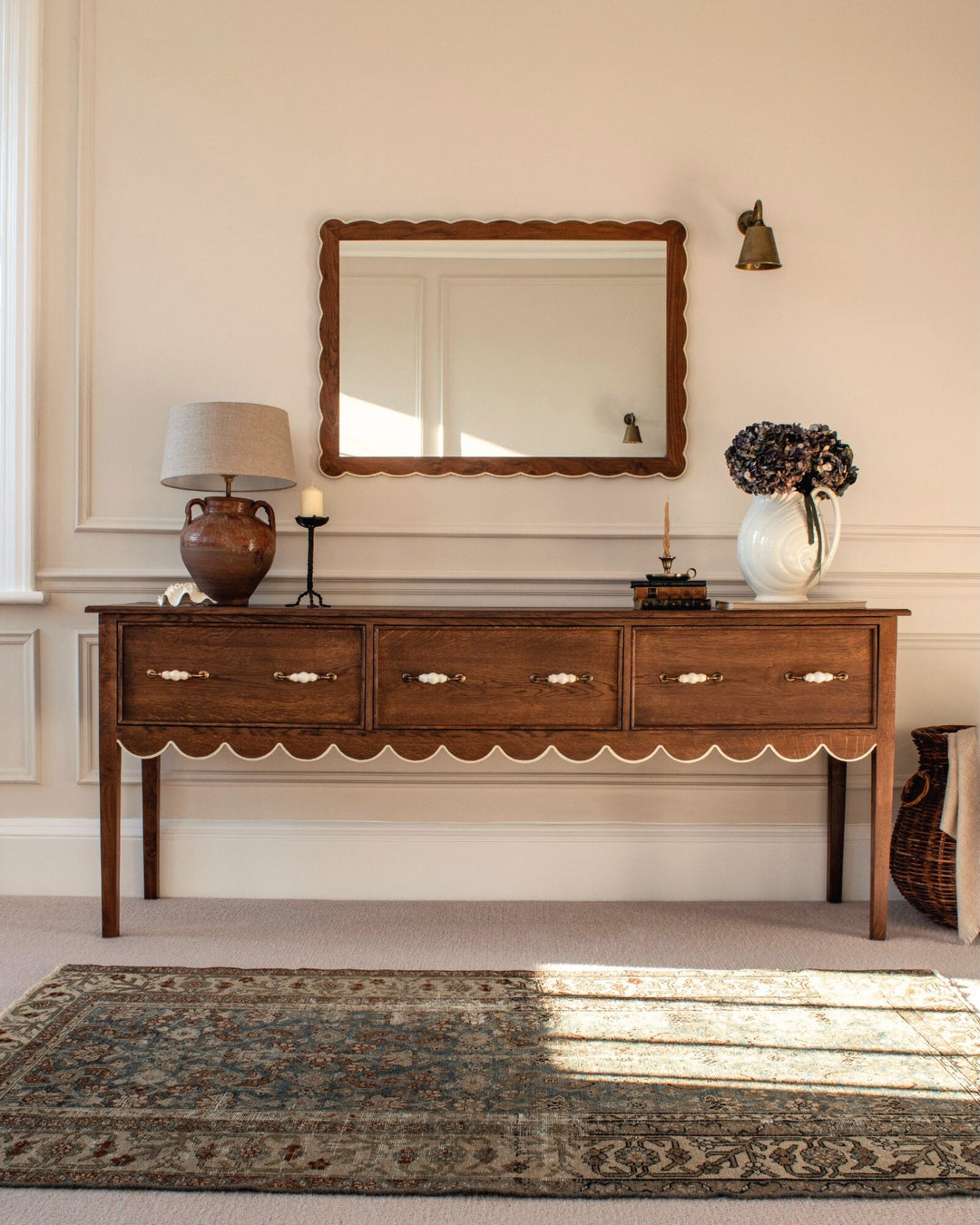 Wooden console table with decorative items in a room setting