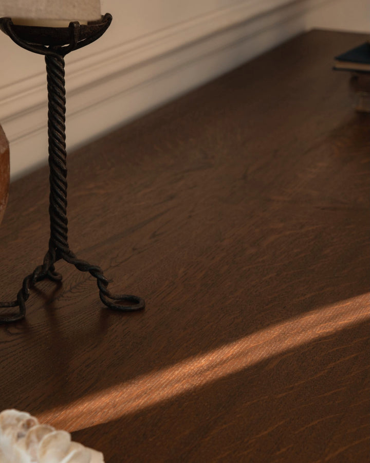 Decorative candle holder on a wooden surface with a blurred background