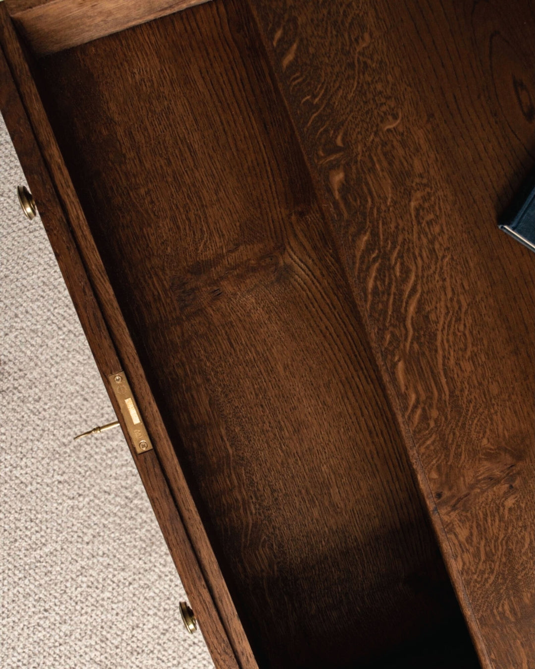 Close-up of a wooden drawer with a visible grain pattern.