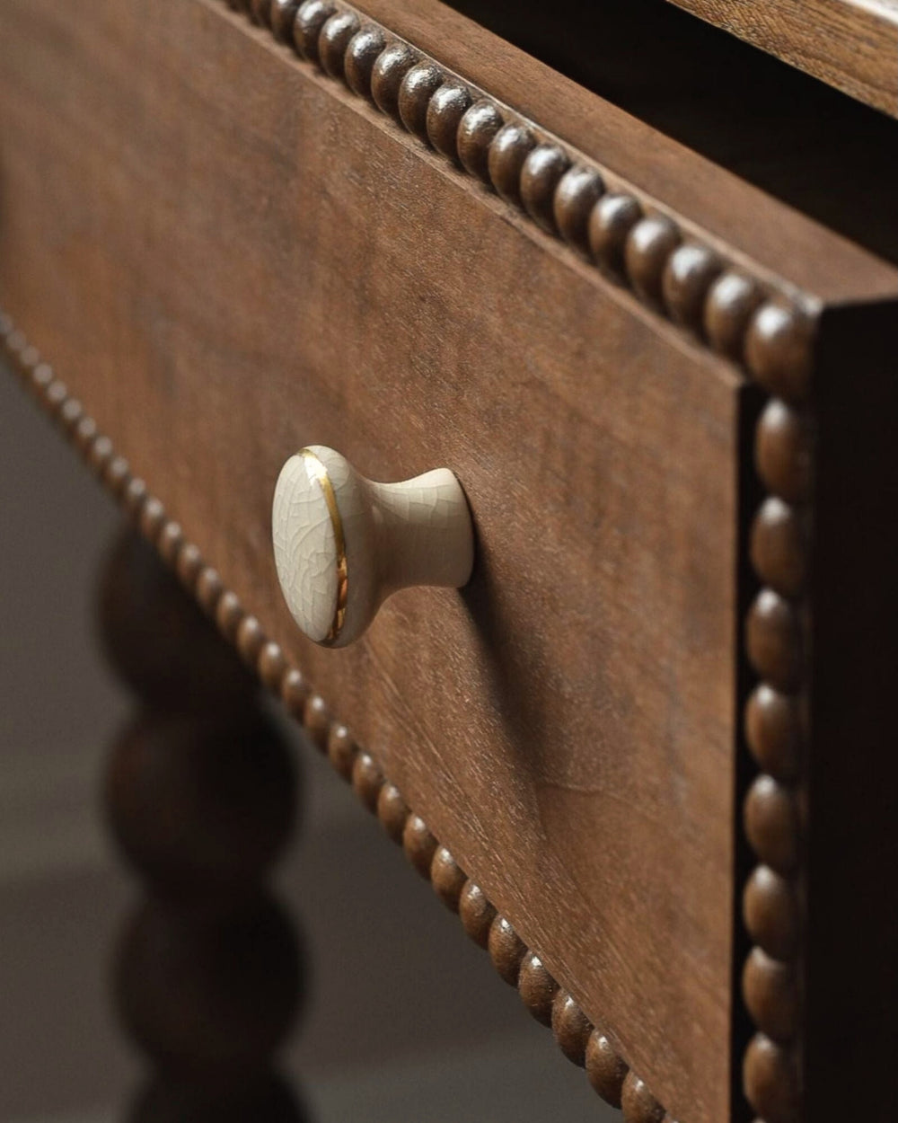 Close-up of a wooden drawer with a knob on a blurred background