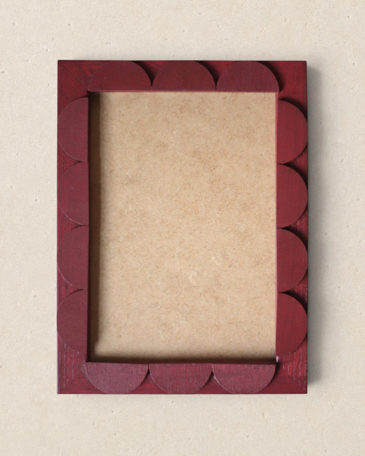 Red decorative picture frame on a beige background