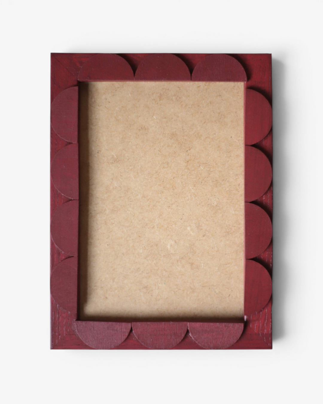 Red decorative picture frame with scalloped edges on a white background