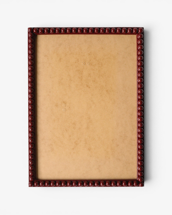 Rectangular dark red bobbin picture frame with a decorative border on a white background