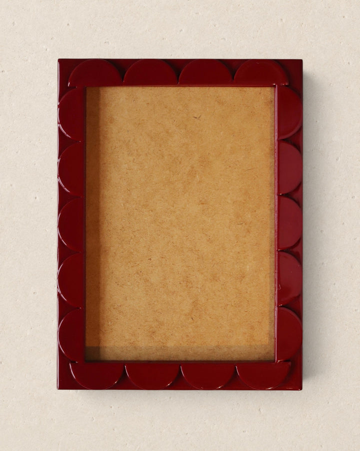 Red decorative picture frame on a beige background