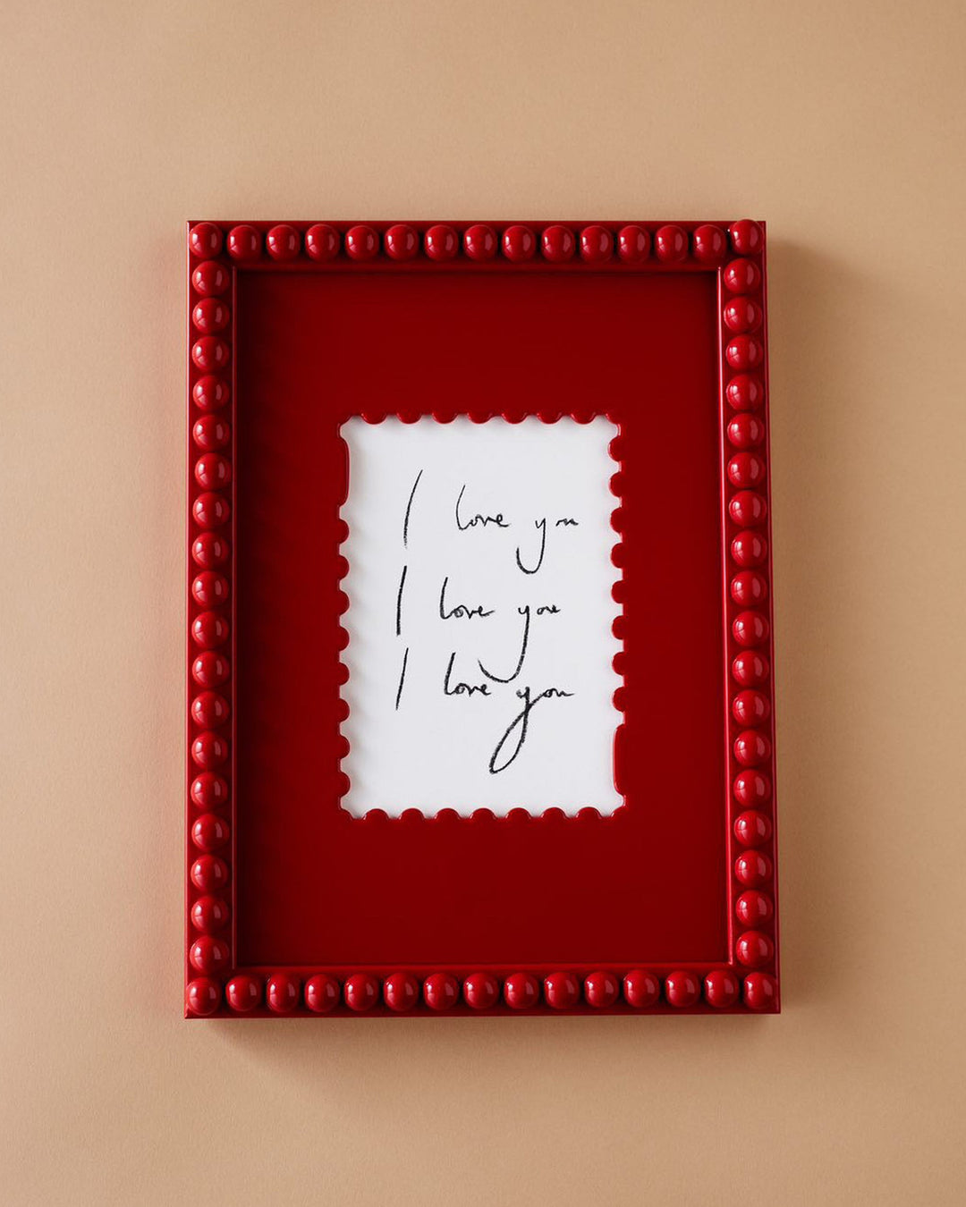 Red framed picture with 'I love you' text on a beige background