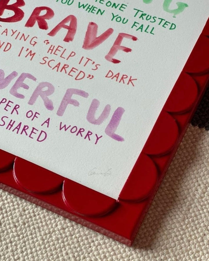 Red frame with motivational text on a textured surface