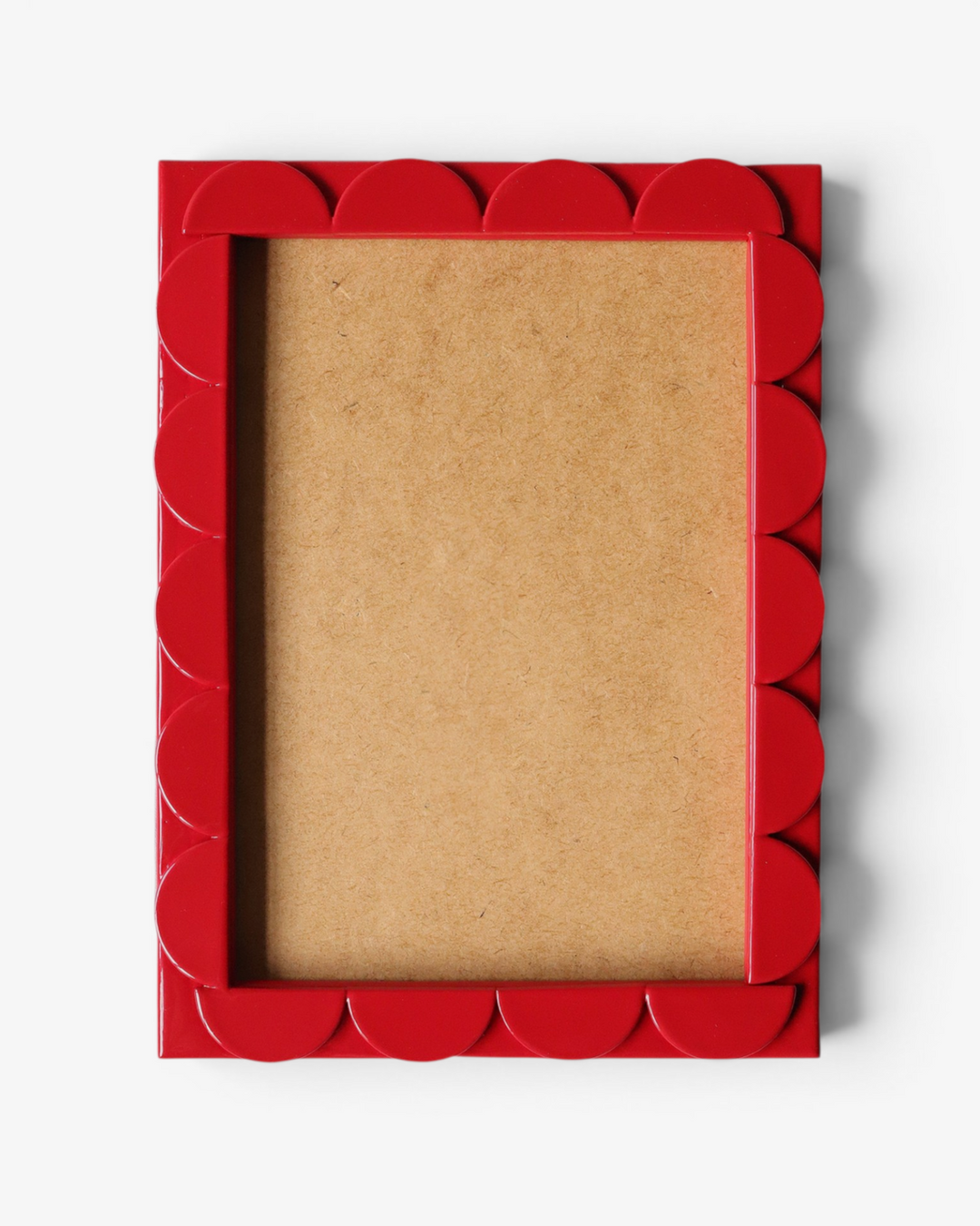 Red scalloped picture frame on a white background
