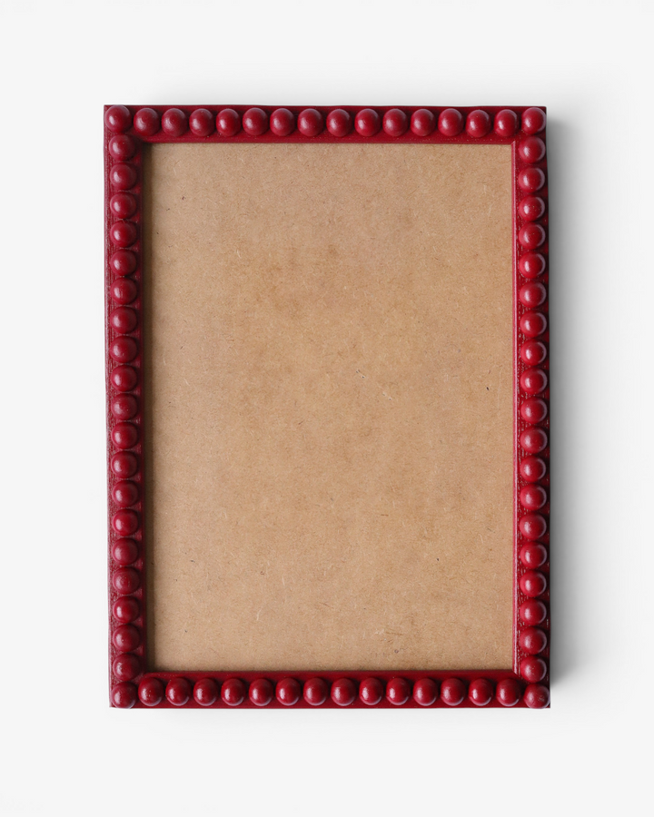Red bobbin picture frame on a white background