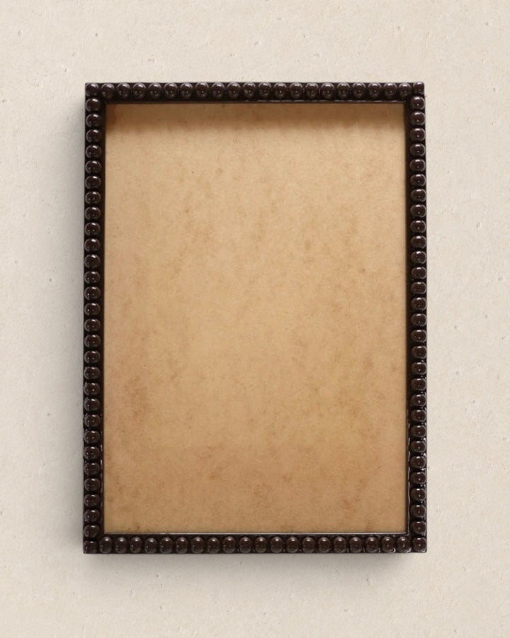 Decorative brown picture frame on a beige background