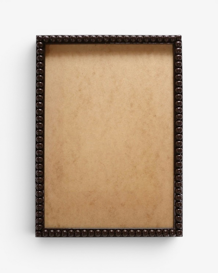 Decorative brown bobbin picture frame on a white background