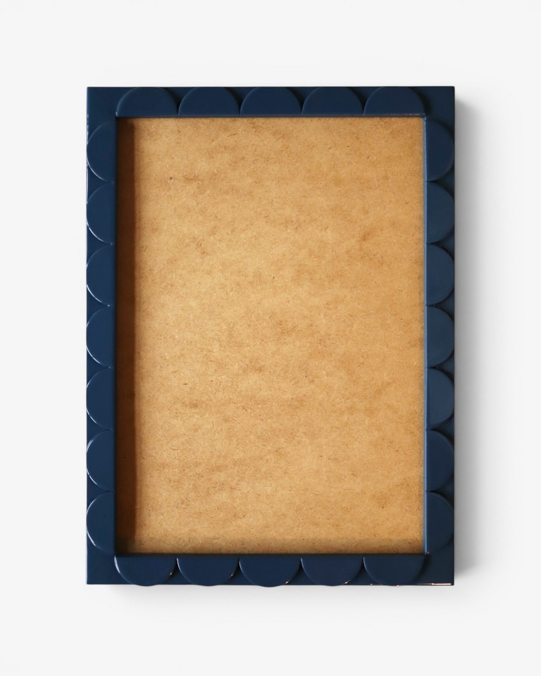 Navy blue picture frame with scalloped edge on a white background