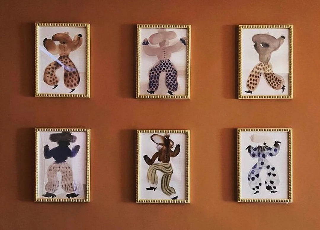 Set of six framed animal portraits on a brown wall