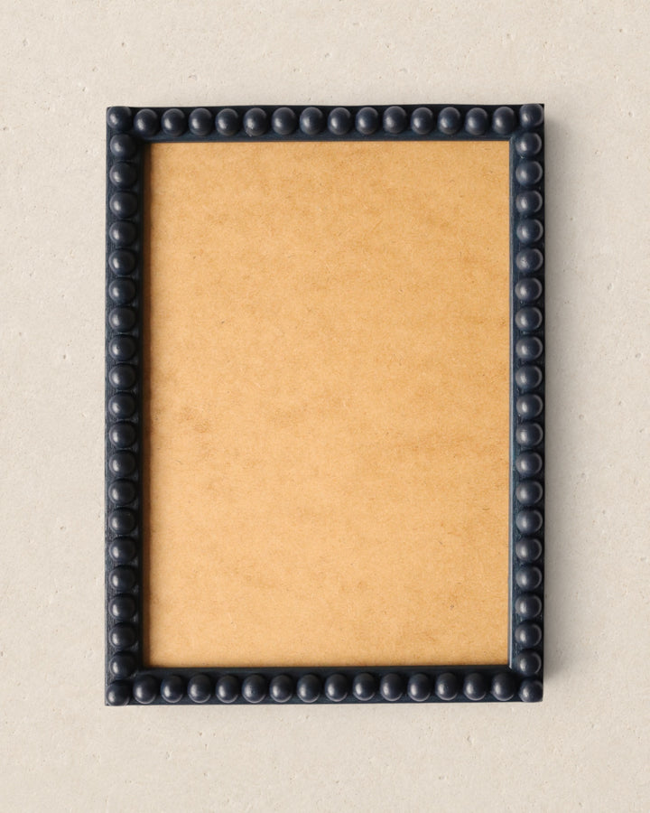 Navy blue framed picture on a beige background