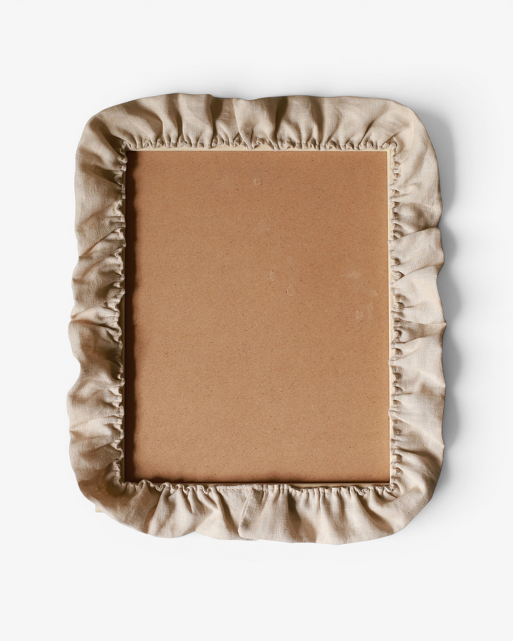 Beige ruffle photo frame on a white background