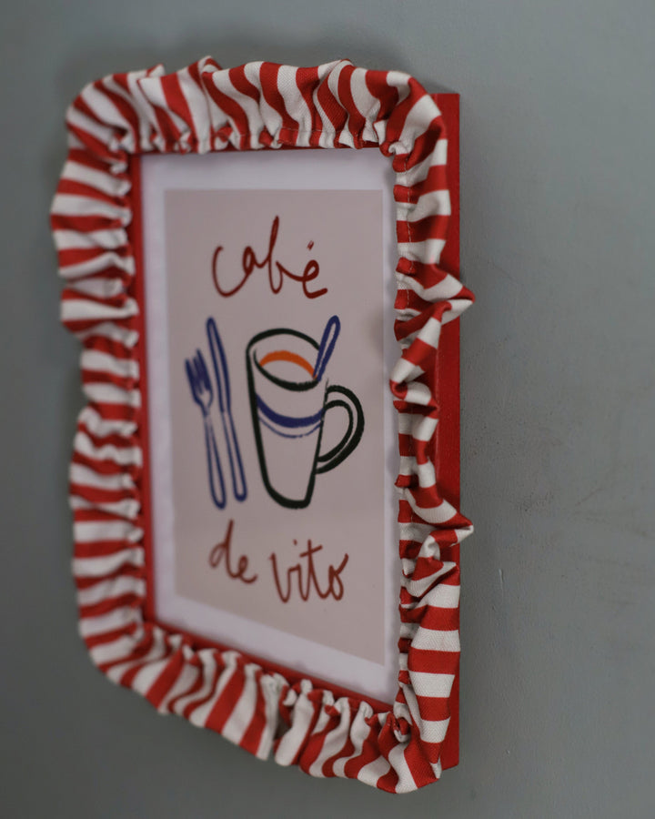 Decorative sign with a red and white striped frame, featuring a coffee cup and utensils illustration.