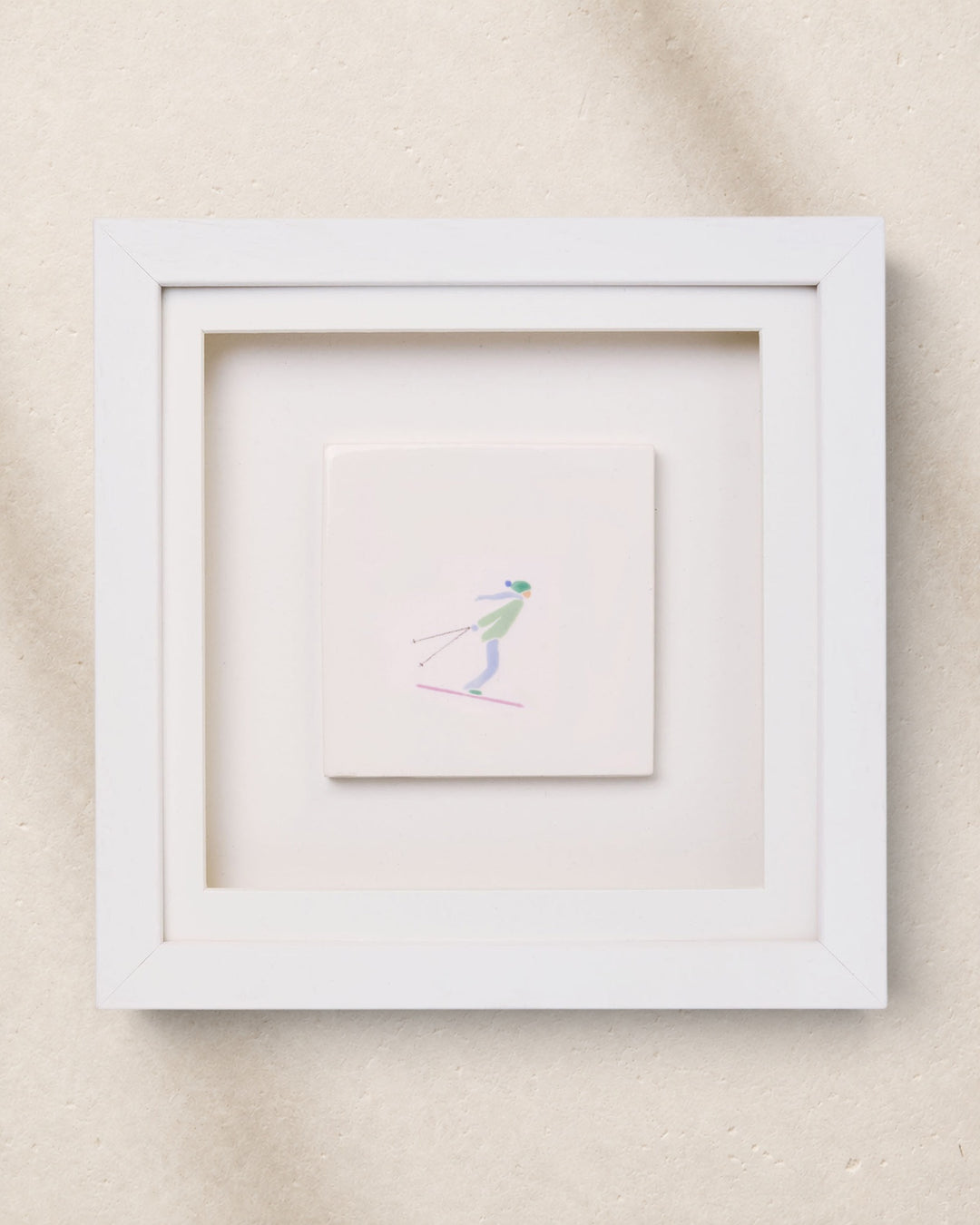 Framed artwork of a skier on a beige background