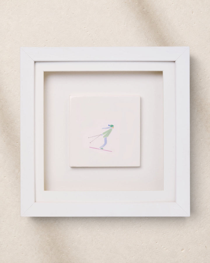 Framed artwork of a skier on a beige background