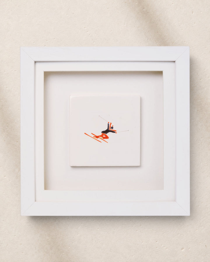 Framed artwork with a small abstract painting inside on a beige background