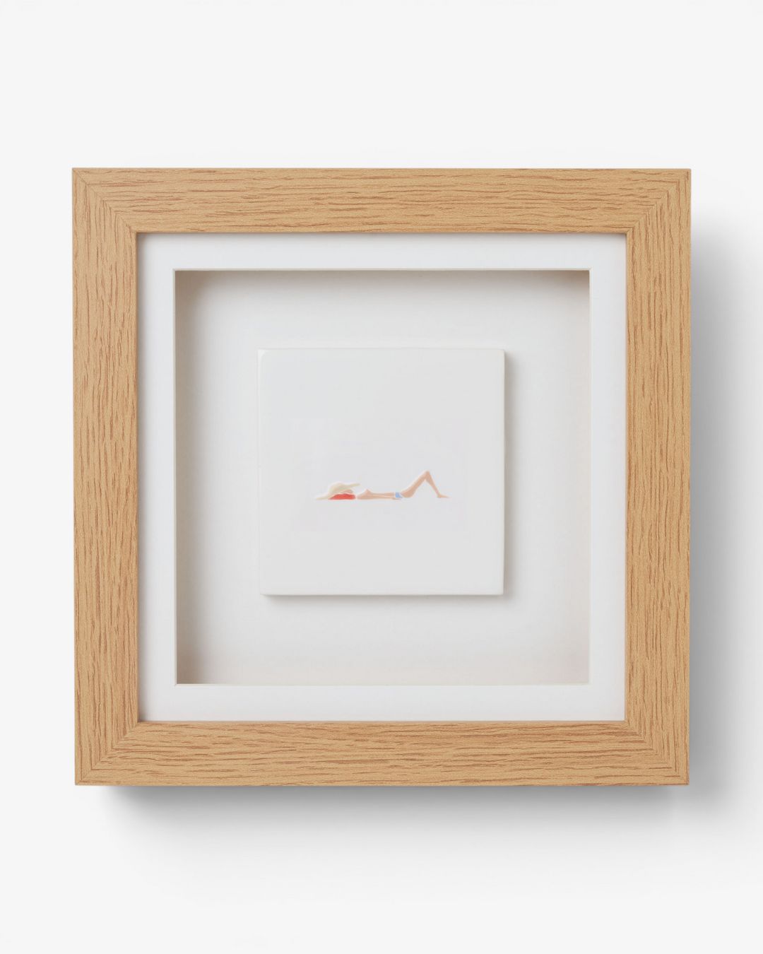 Wooden picture frame with artwork inside on a light gray background