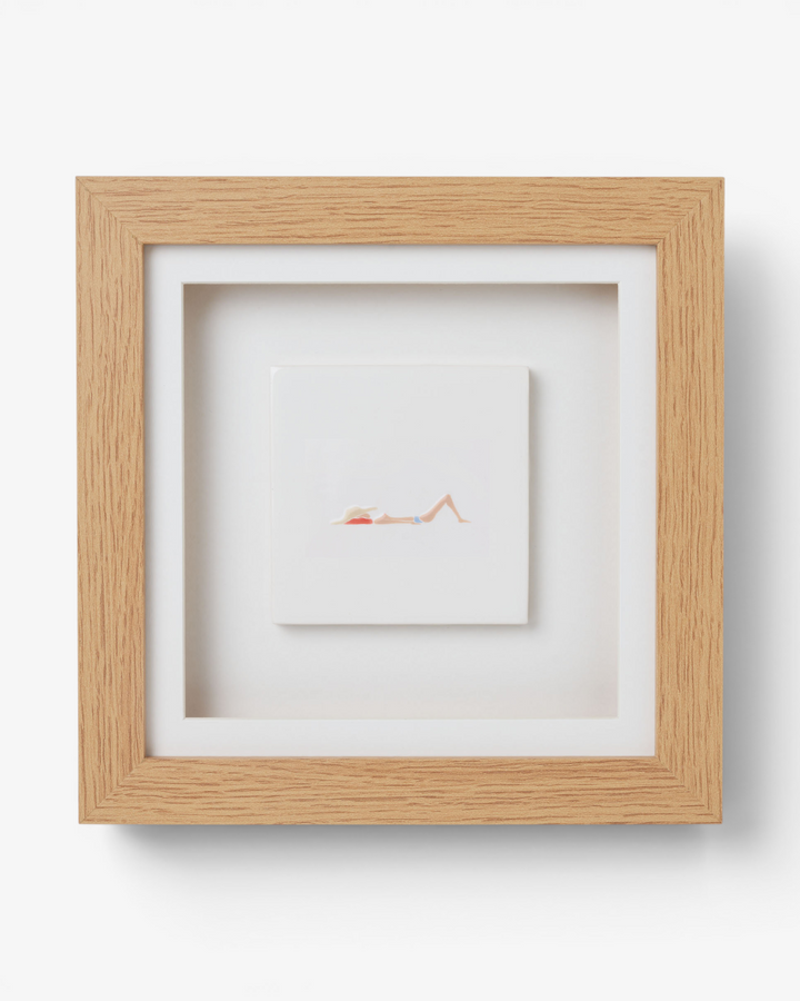 Wooden picture frame with artwork inside on a light gray background