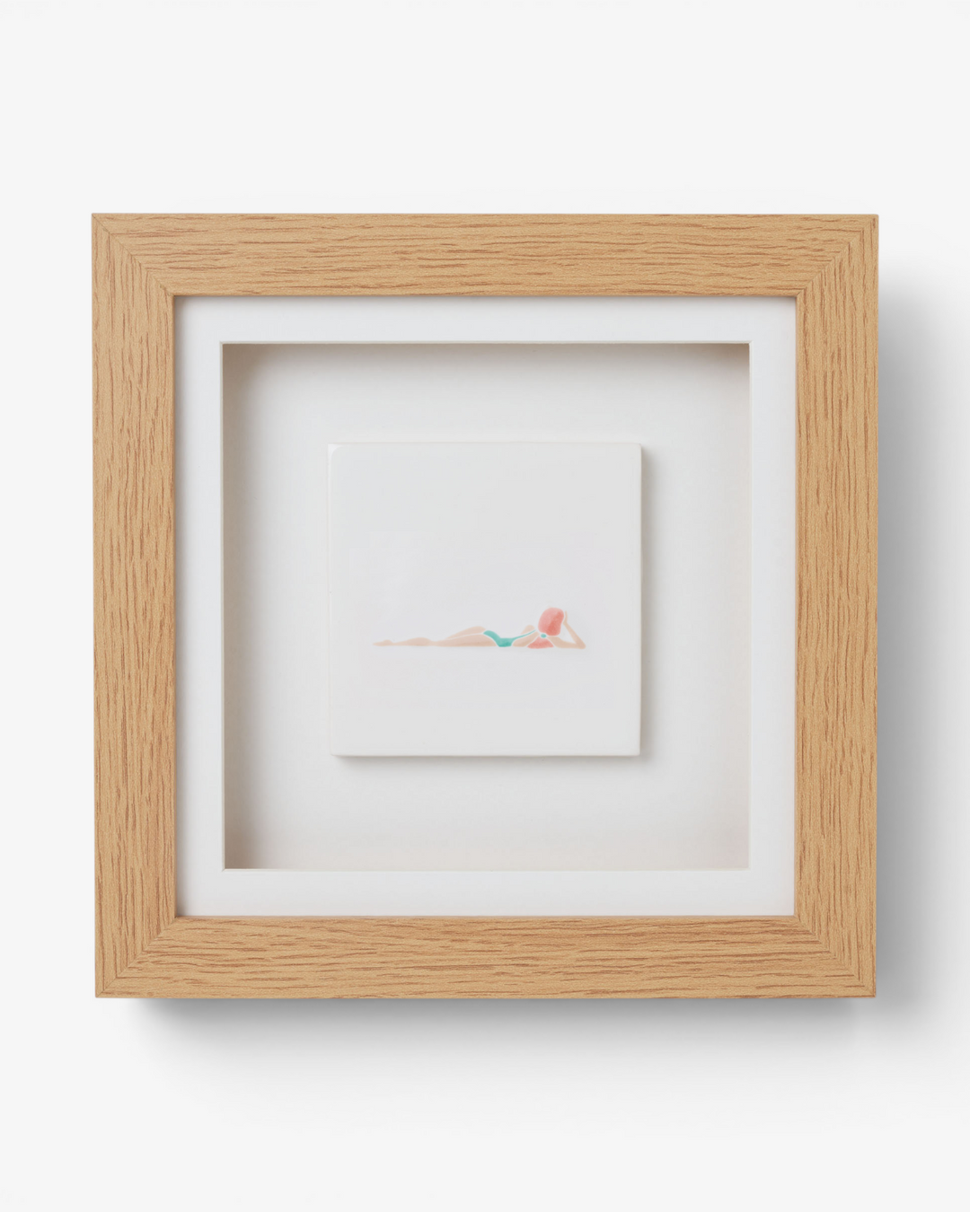 Wooden picture frame with  artwork inside on a light gray background
