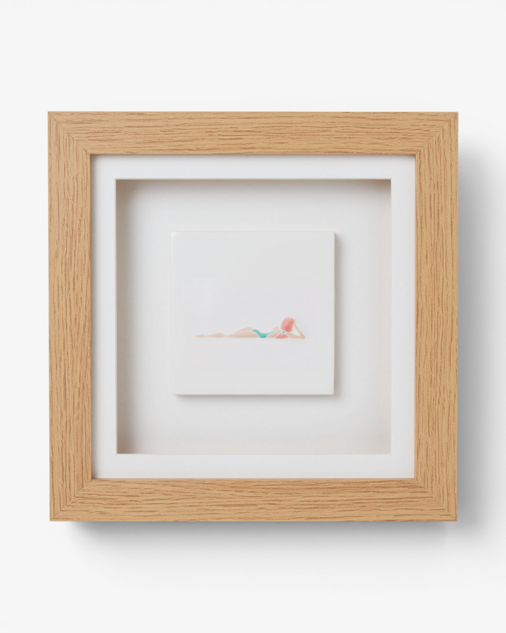 Wooden picture frame with  artwork inside on a light gray background