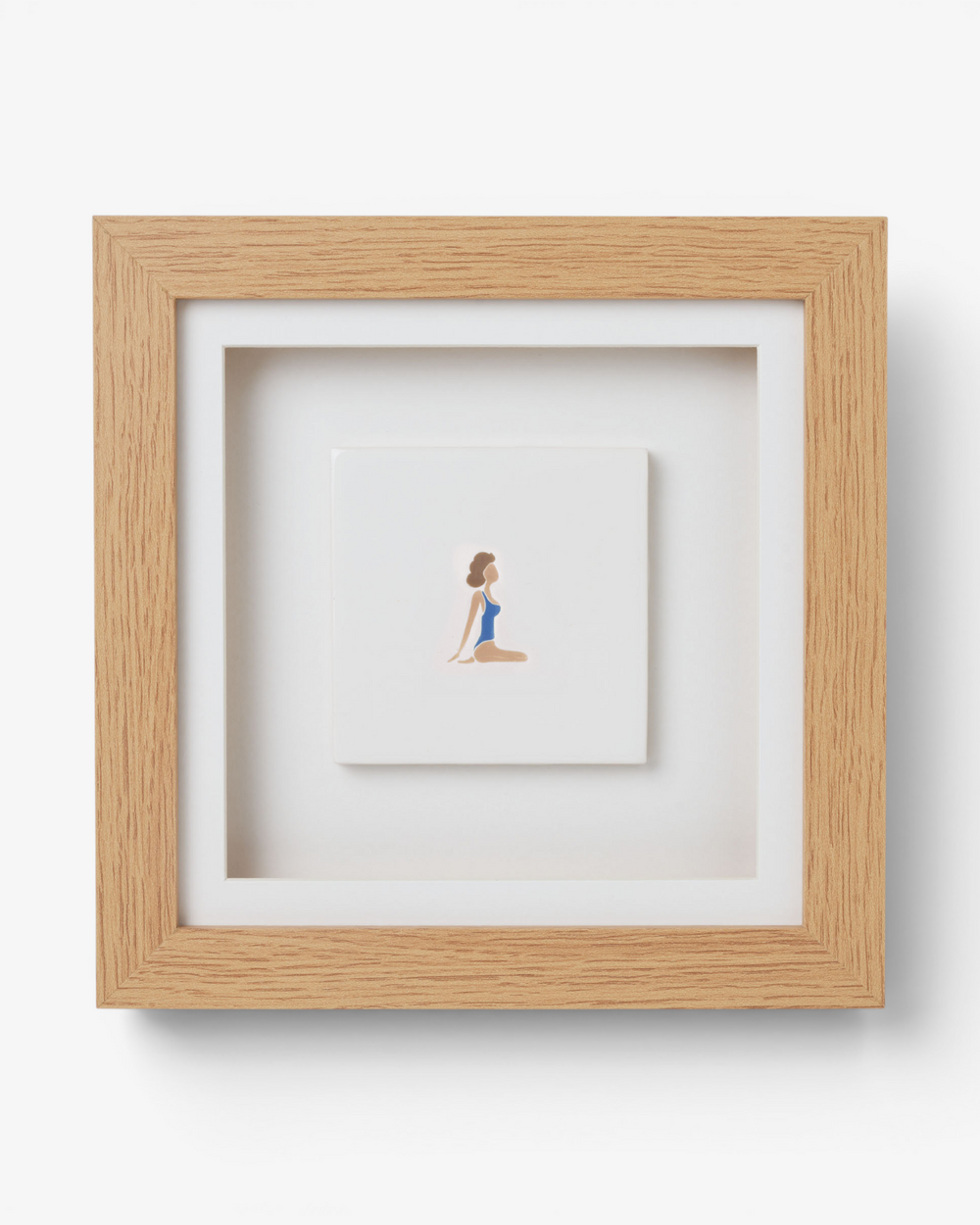 Framed artwork of a woman in a blue swimsuit on a white background