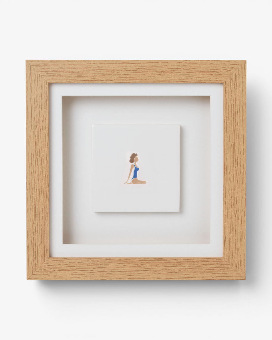 Framed artwork of a woman in a blue swimsuit on a white background