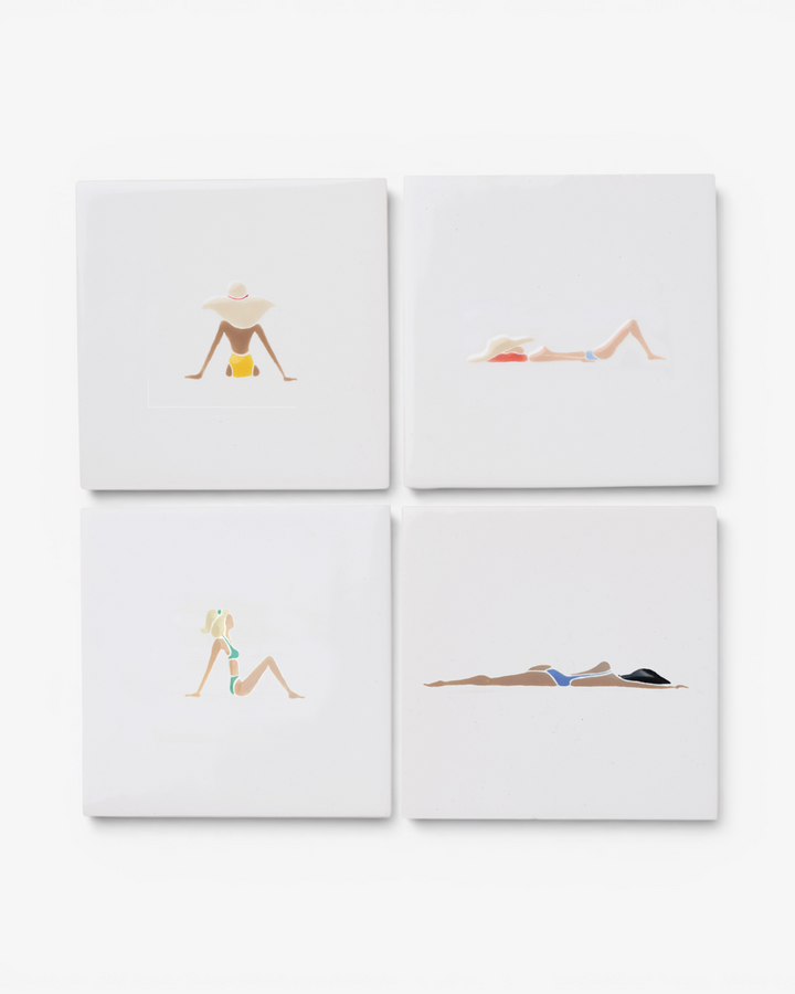 Four square ceramic coasters with illustrations of women in swimsuits on a white background