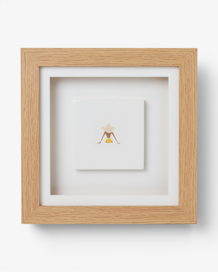 Wooden picture frame with artwork inside on a white background