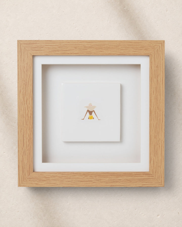 Framed artwork with a minimalist design on a beige wall
