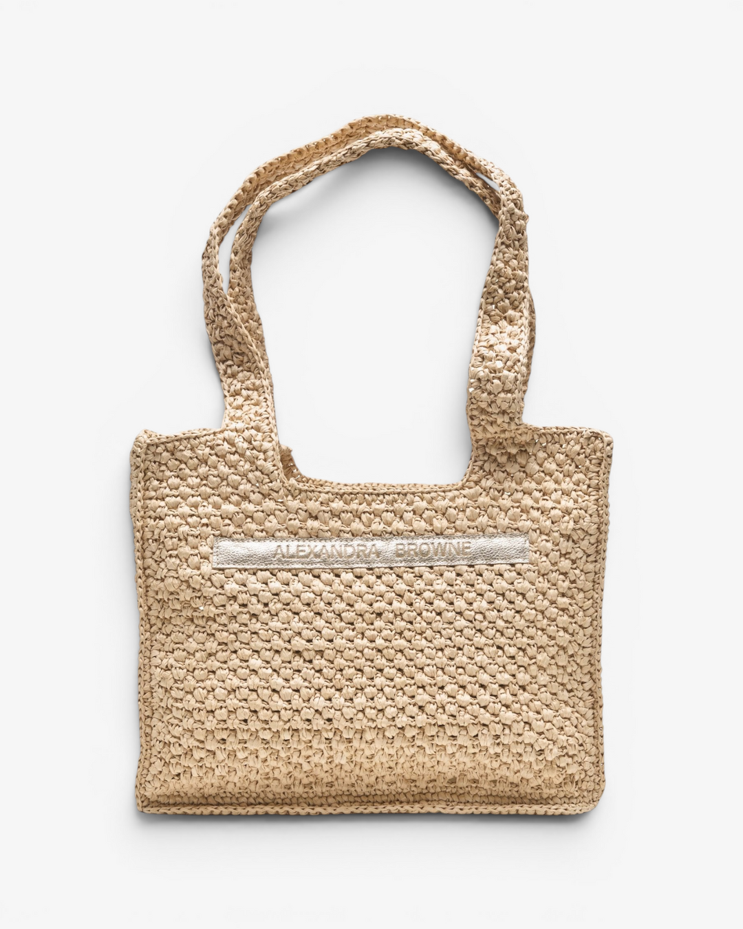 Woven handbag with a metallic logo on a white background