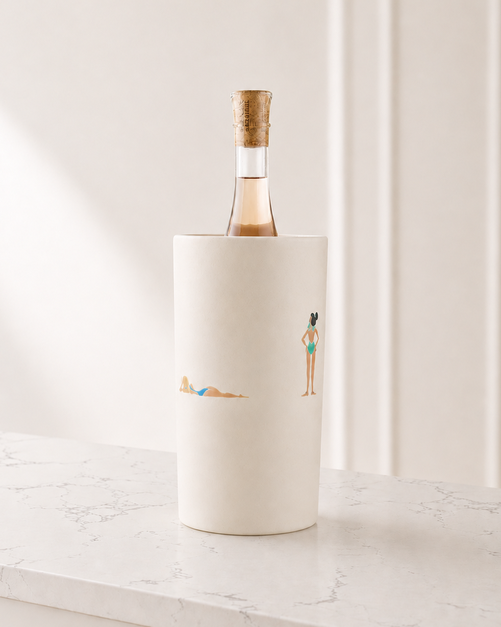 White wine bottle cooler with illustrations of people on a marble surface