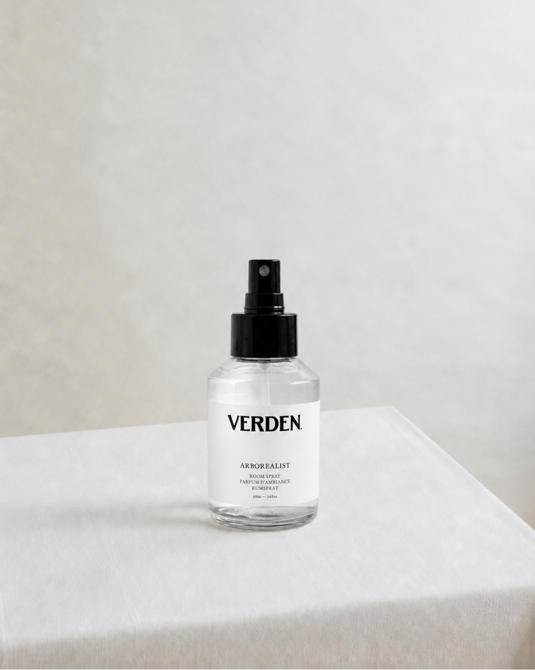 Clear spray bottle with black nozzle and 'VERDEN' label on a white surface.