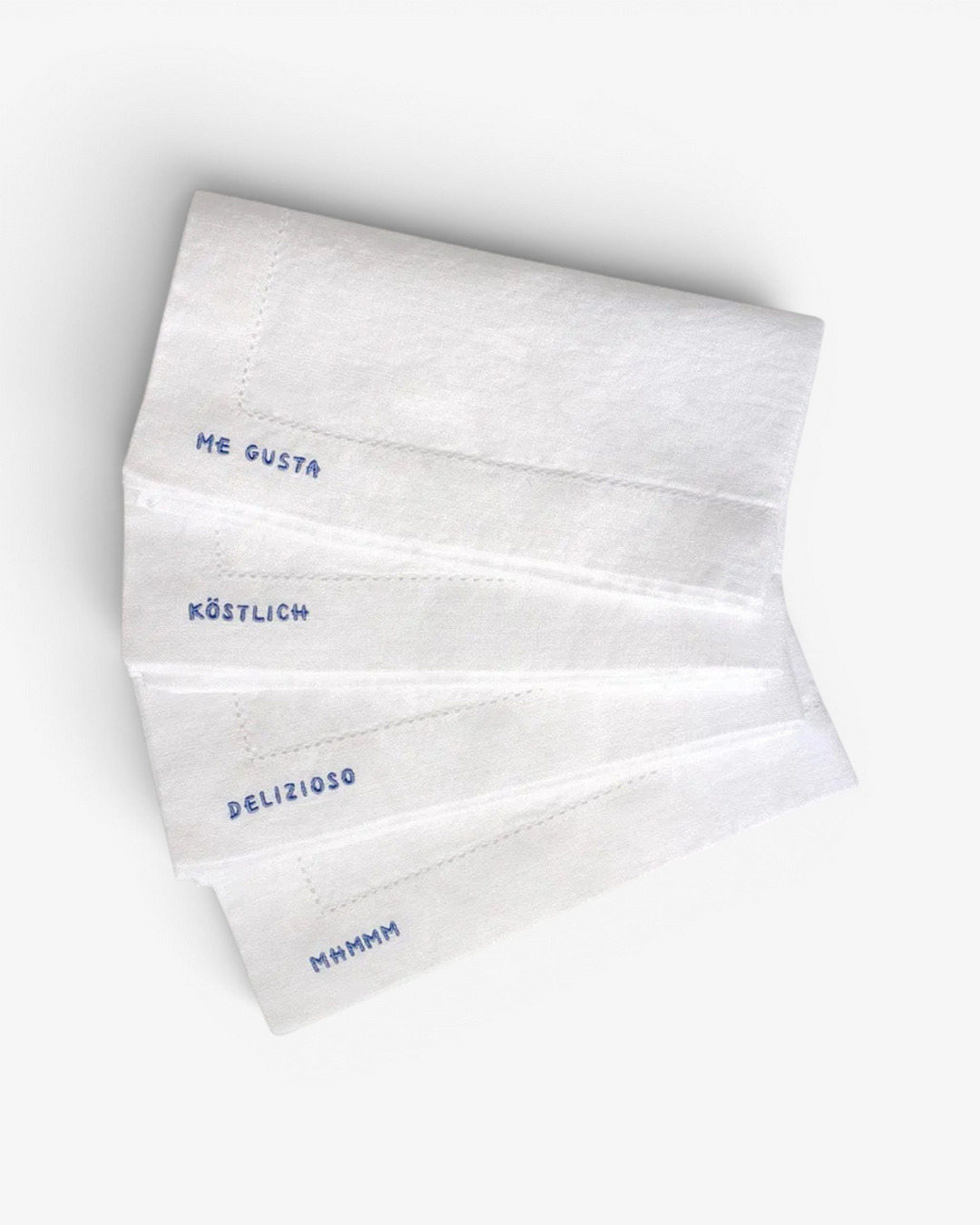 Set of white napkins with text on a light gray background