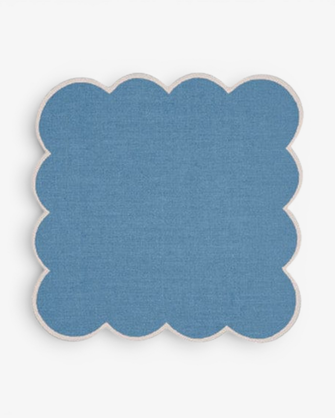 Blue scalloped cocktail napkin coaster on a white background