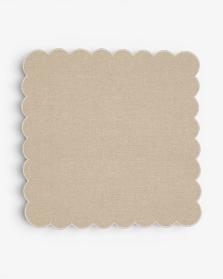 Beige scalloped napkin on a white background