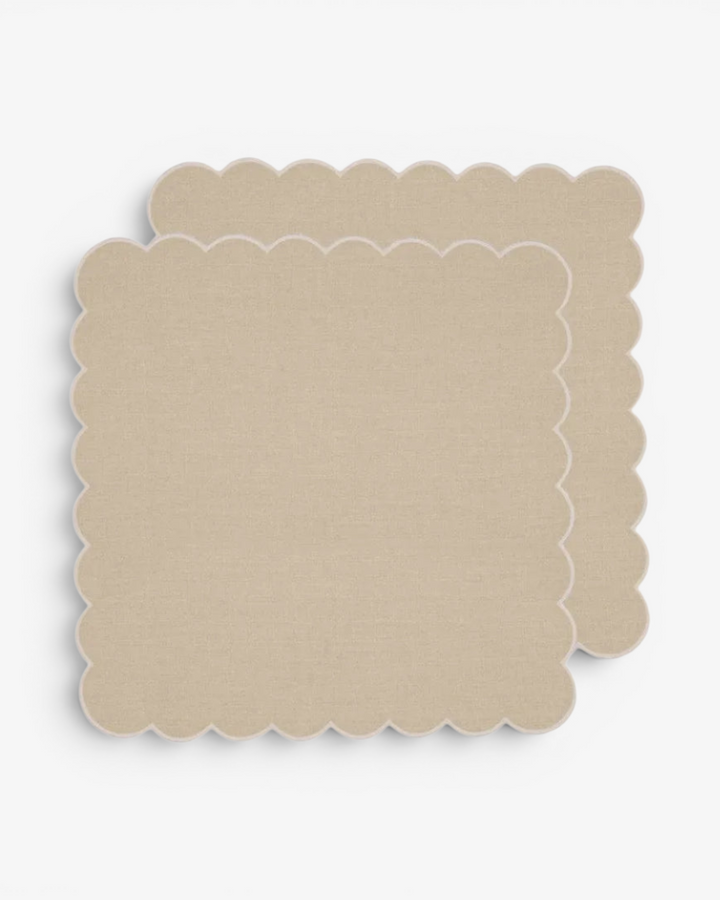 Beige scalloped napkin on a white background