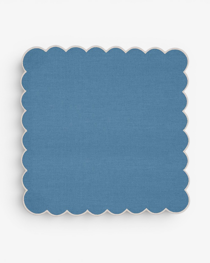 Blue scalloped napkin on a white background
