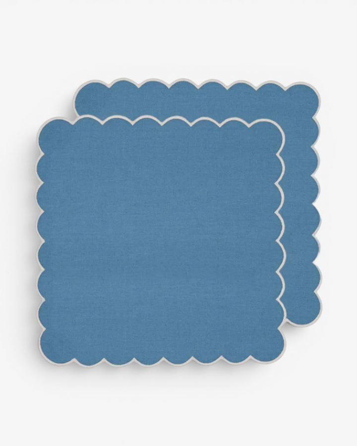 Blue scalloped napkins on a white background