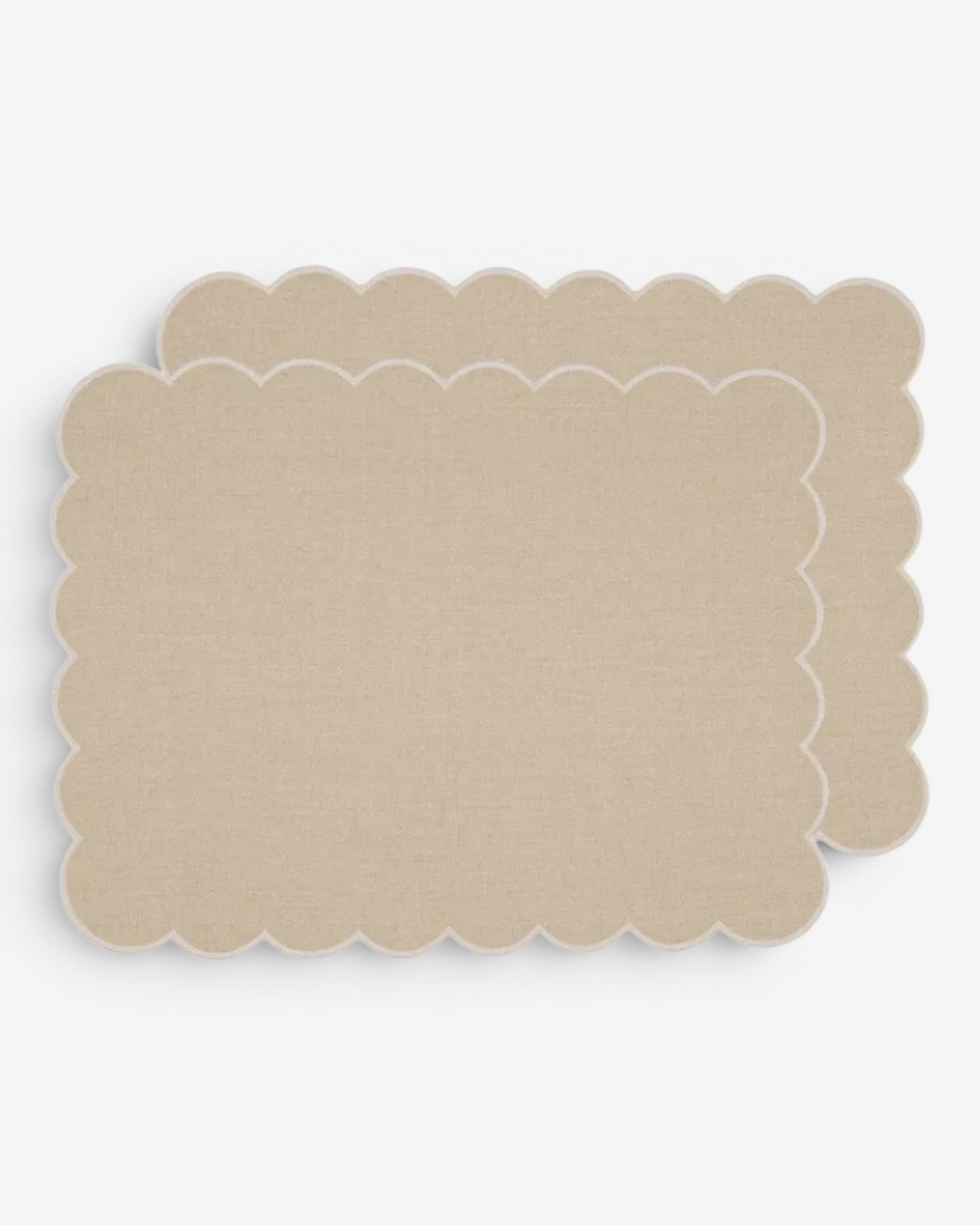 Beige scalloped placemat on a white background