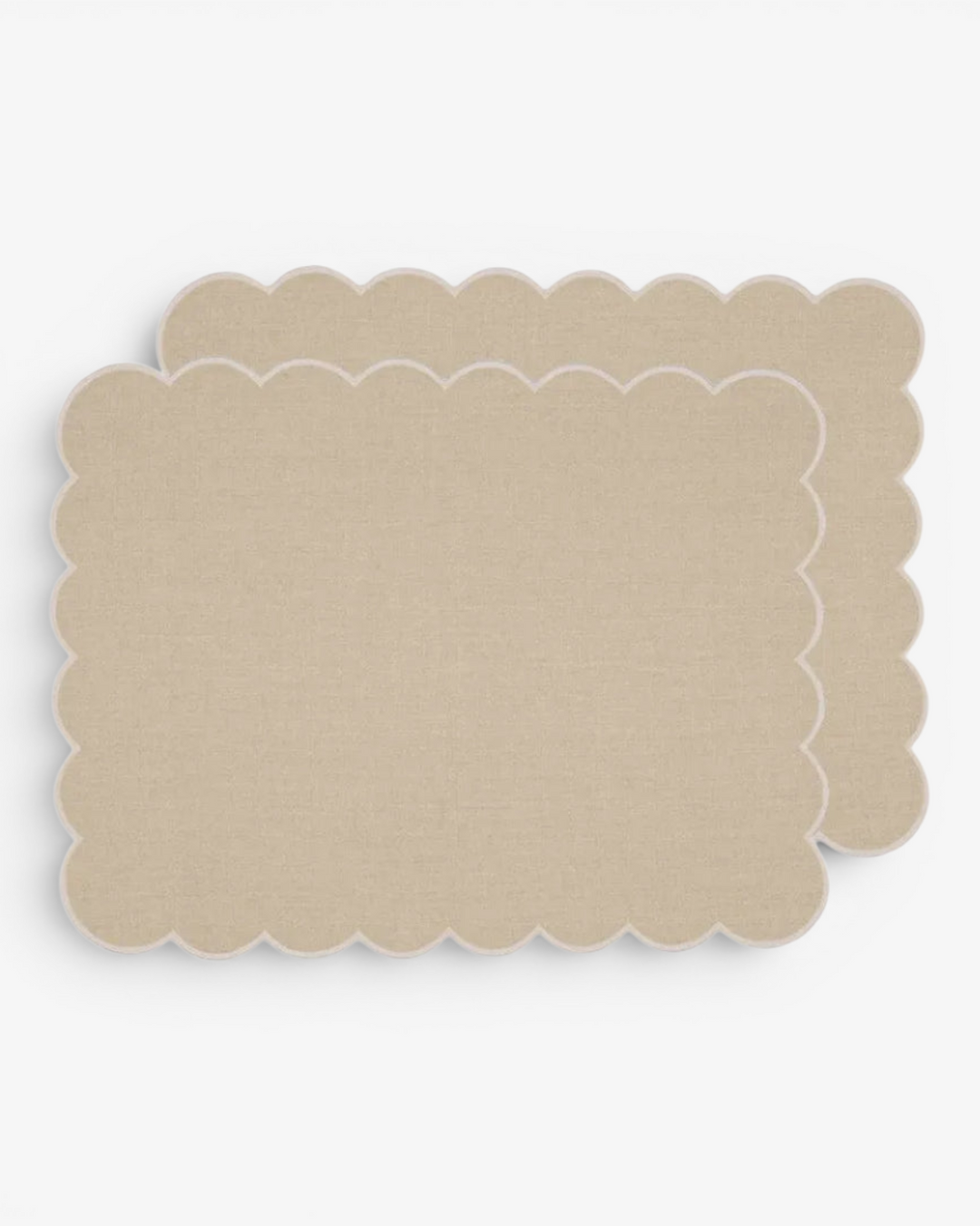 Beige scalloped placemat on a white background