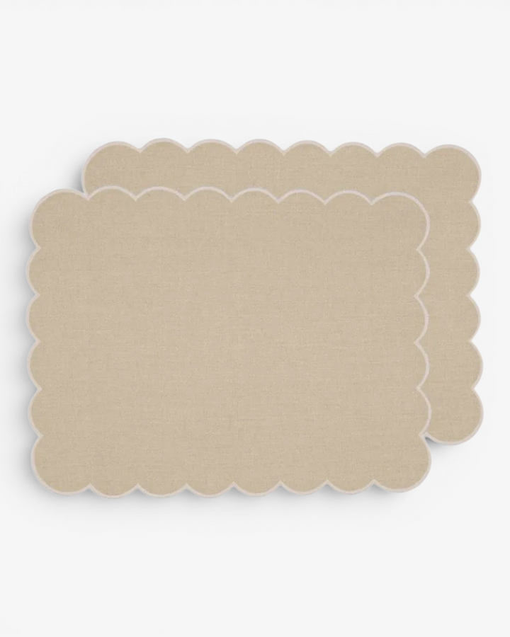 Beige scalloped placemat on a white background