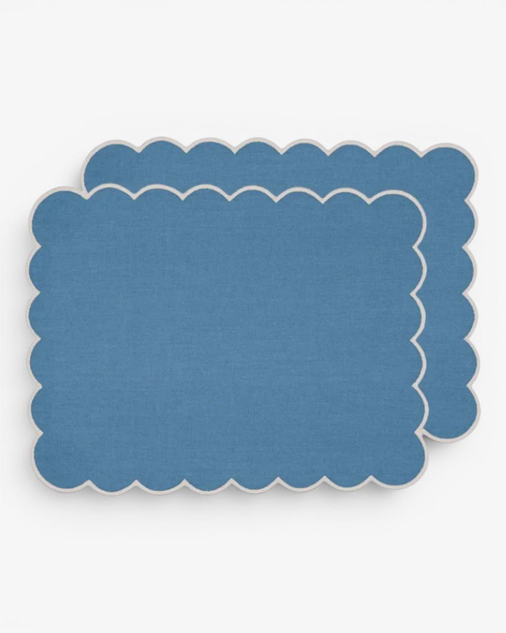 Blue scalloped placemat on a white background