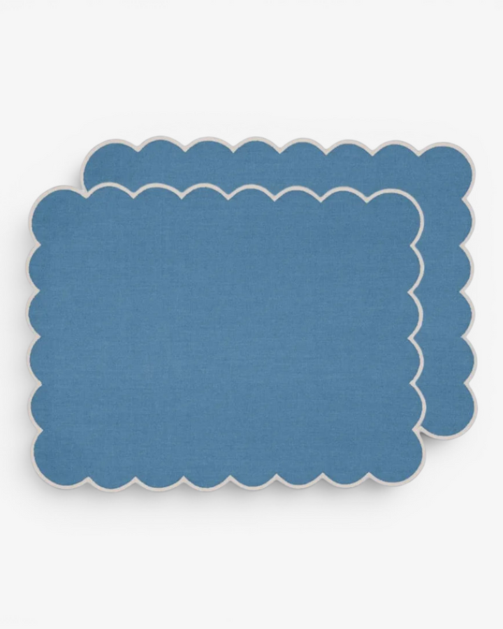 Blue scalloped placemat on a white background