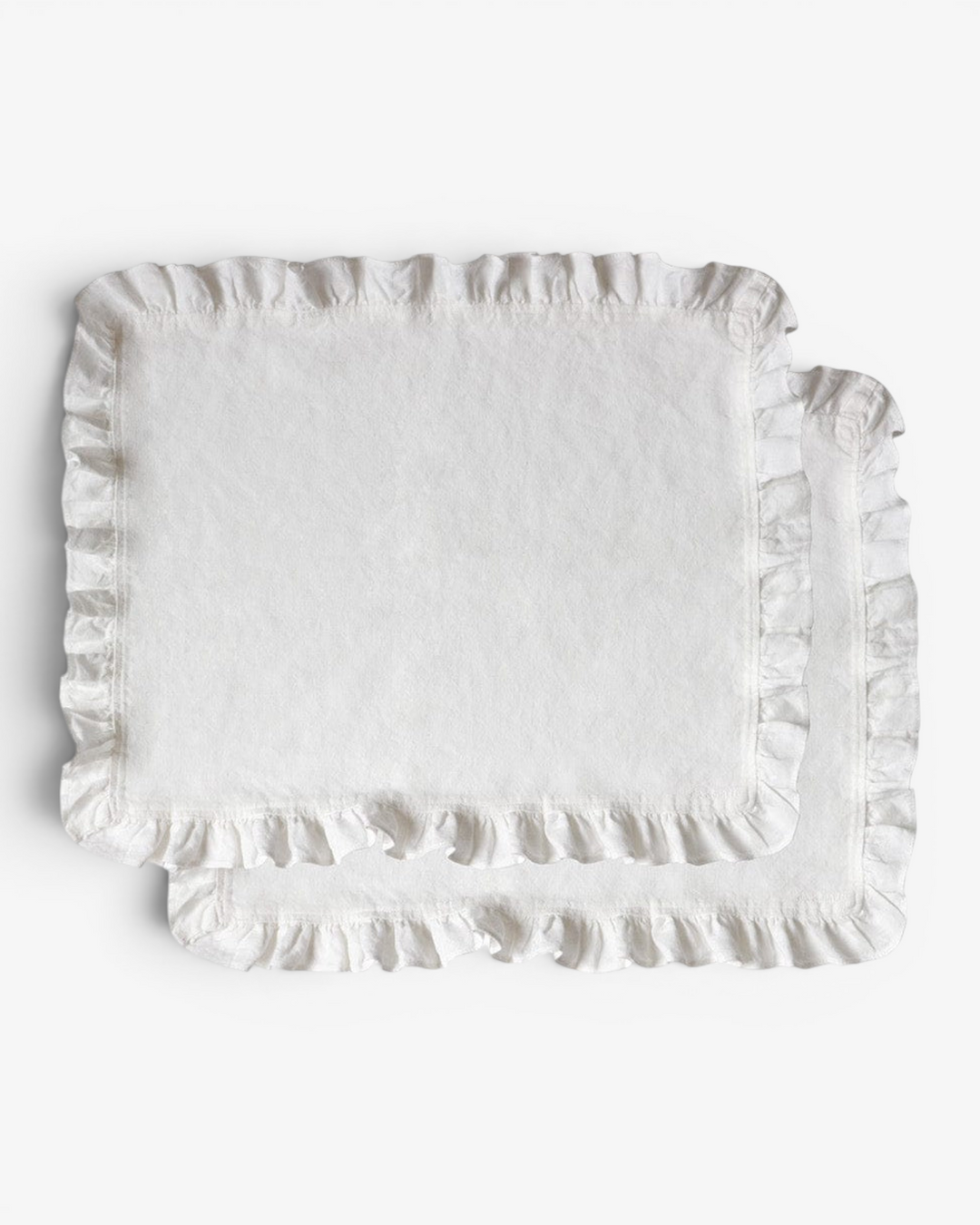 Rectangular white placemat with ruffled edge on a light gray background