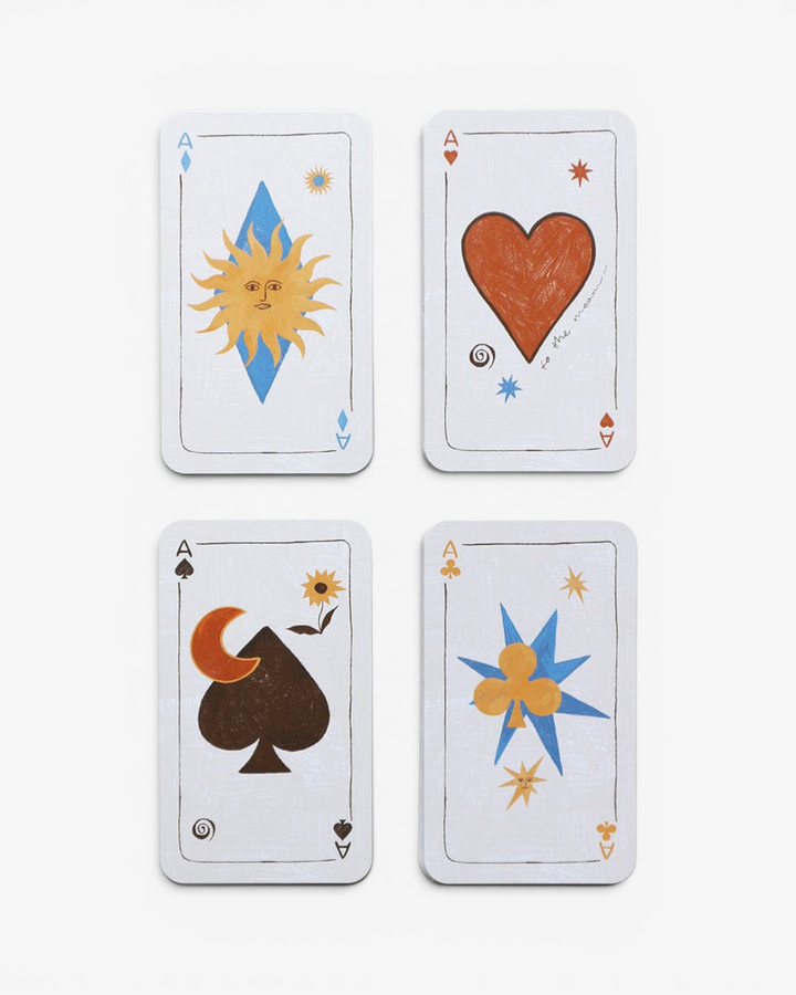 Four playing cards with unique symbols on a white background