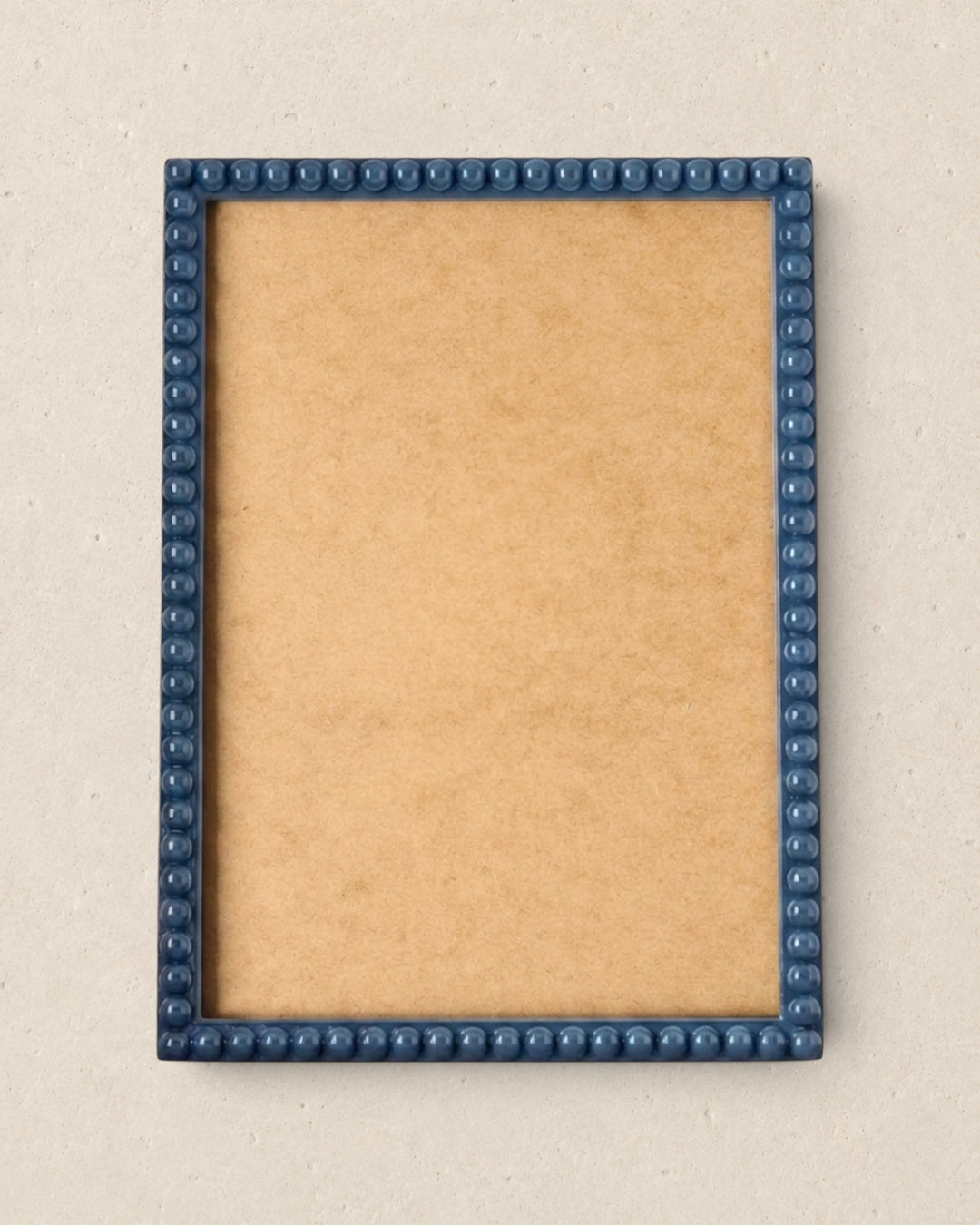 Picture frame with blue border on a beige background